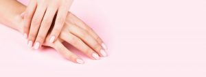 Banner with Woman's Hands with Pastel Manicure on Pink Background.
